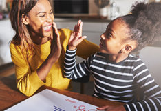 mother high fiving daughter
