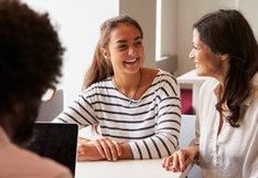 student smiling at adult
